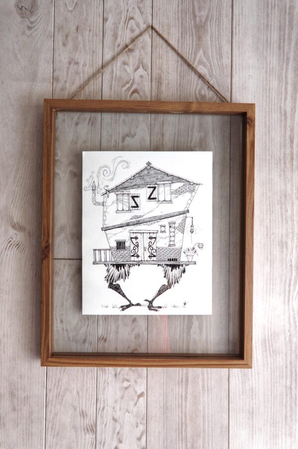 tableau en bois et verre avec une illustration d'une maison sur des jambes