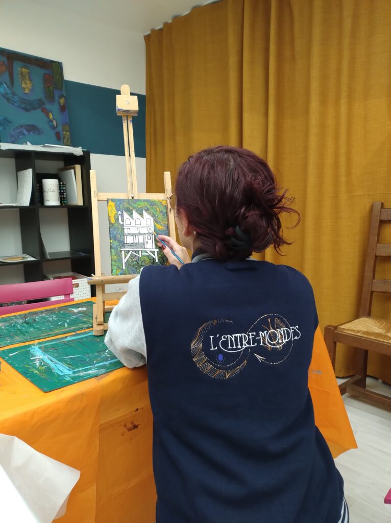 artiste de dos en train de peindre